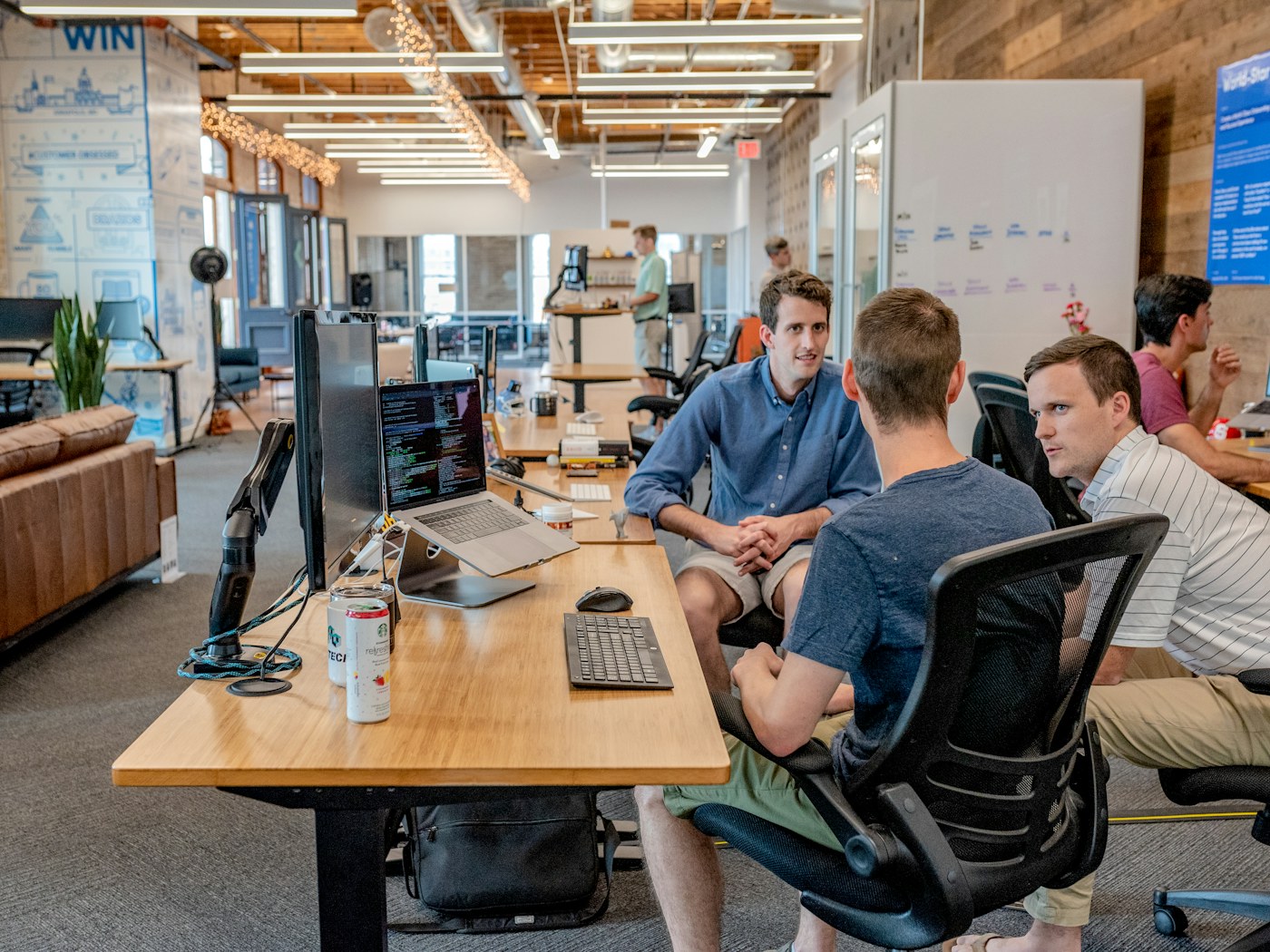 Colleagues collaborating on a digital project in a corporate workspace